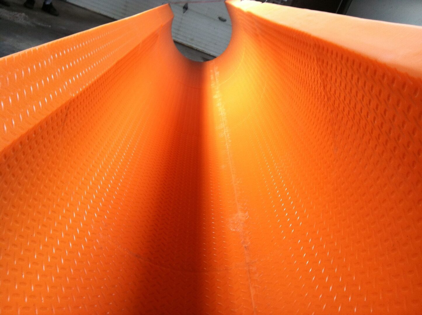 A close up of an orange tube with a white object in it