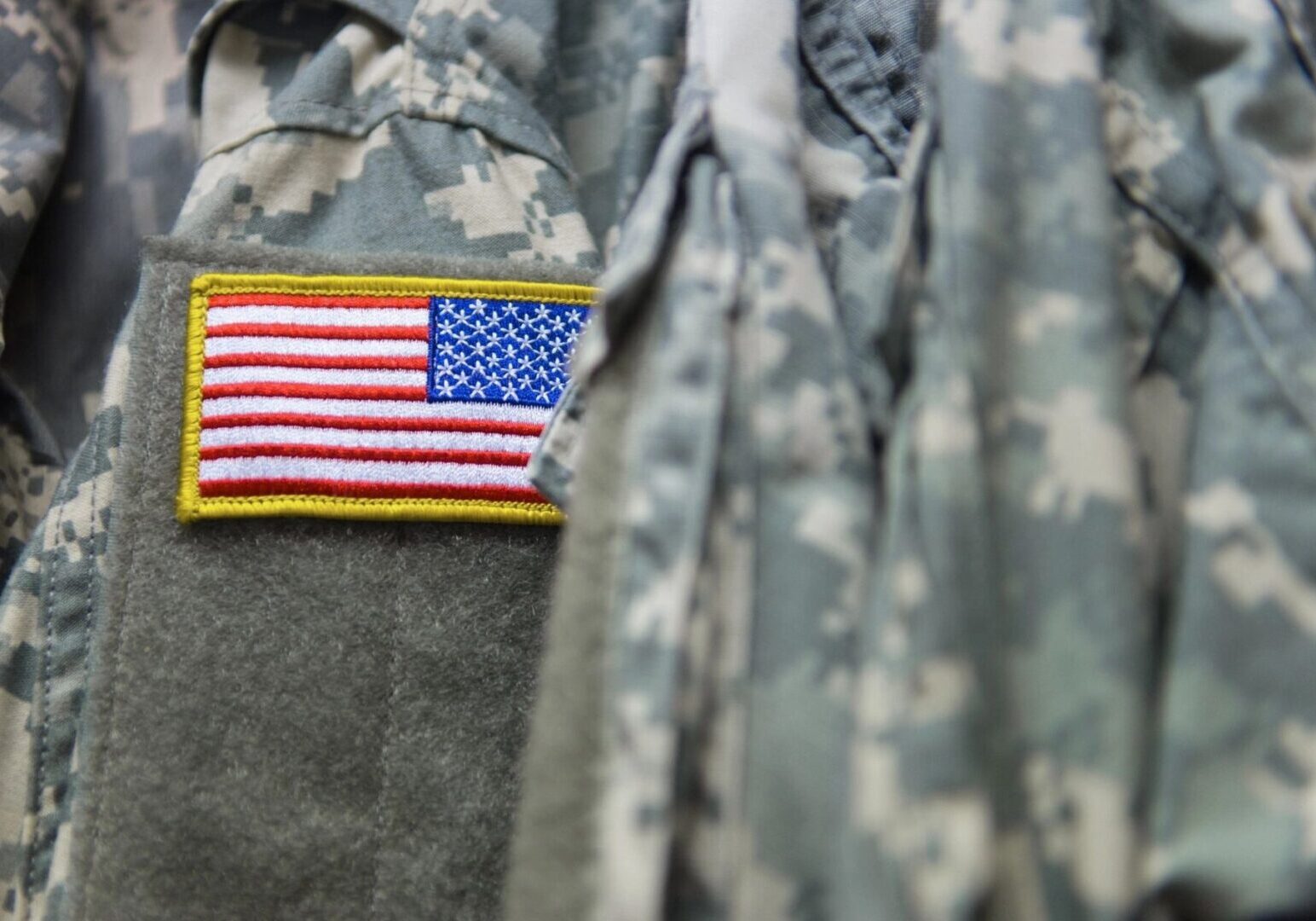 A close up of the american flag patch on a uniform.